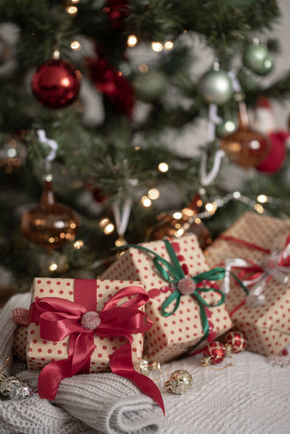 Beautifully wrapped gift boxes under the Christmas tree, close-up, winter holidays concept. - Valokuva, kuva