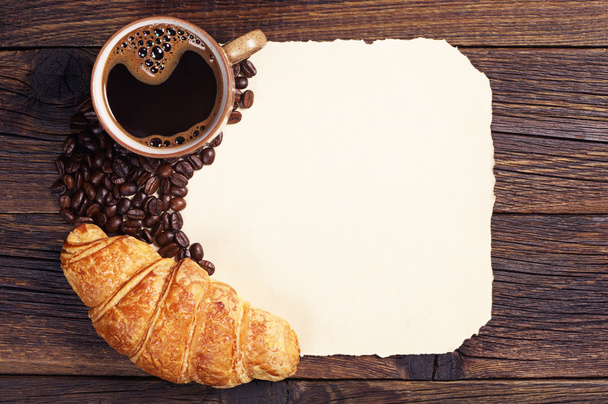 Croissant, coffee cup and old paper - Photo, Image