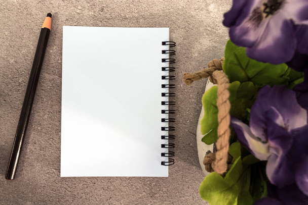 Note book with pen and potted plant on marble table. Directly above. Flat lay. Copy space. - Foto, Bild