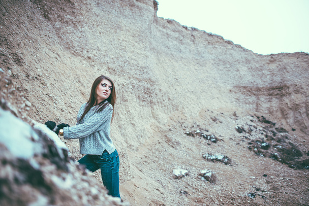 Pretty young woman outdoor in quarry with sand - Photo, Image