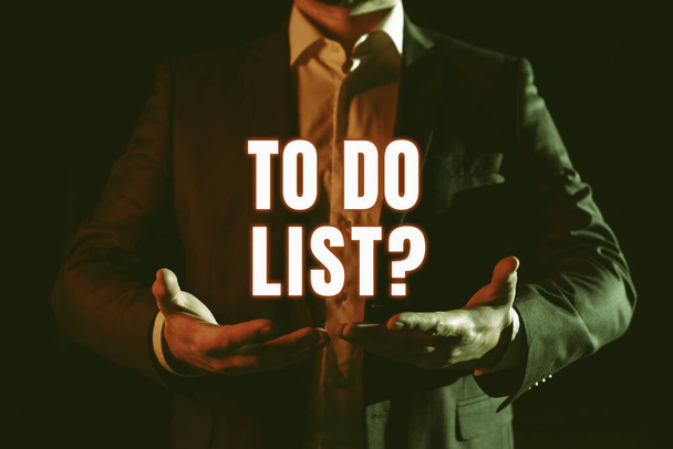 Hand writing sign To Do List Question, Word for Series of task to be done organized in priority order Businessman Holding And Presenting Important Informations On Hands. - Foto, Bild