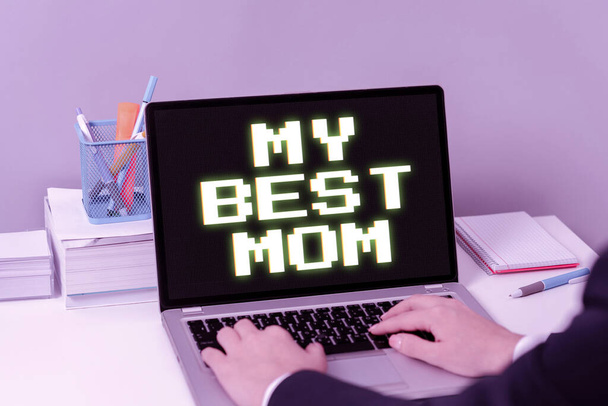 Conceptual caption My Best Mom, Internet Concept Admire have affection good feelings love to your mother Businesswoman Typing Recent Updates On Lap Top Keyboard On Desk. - Foto, Imagen