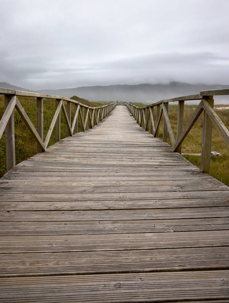 Laxe (Spain), August 20, 2022. Wooden footbridge. Footbridge to cross the dunes of Traba beach. - 写真・画像