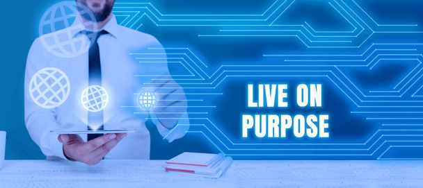Conceptual caption Live On Purpose, Business approach Have a goal mission motivation to keep going inspiration Businessman Holding Tablet And Presenting Crutial Messages In Office. - Photo, image