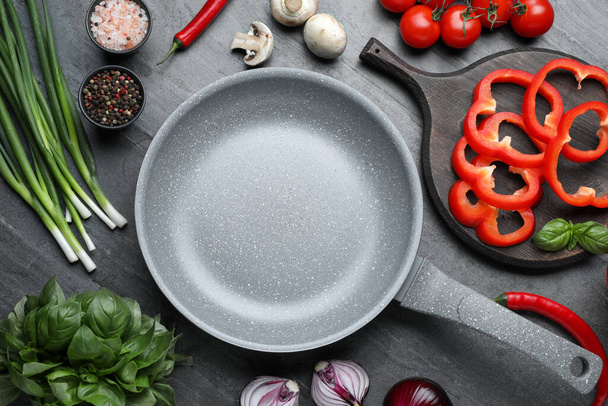 Flat lay composition with frying pan and fresh products on grey table - Foto, Bild