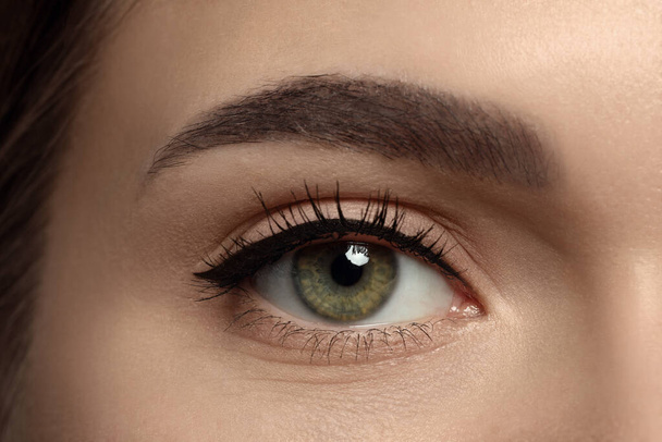 Young woman with permanent makeup of eyes and brows, closeup - Photo, image