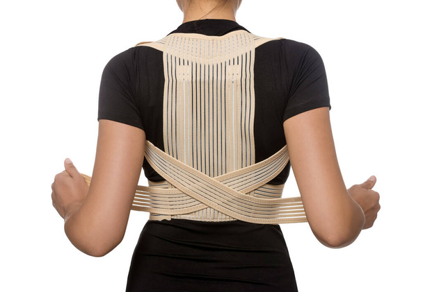 Closeup of woman with orthopedic corset on white background, back view - Foto, imagen