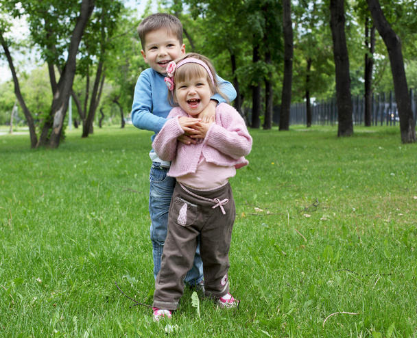Happy sister and brother outdoors - Foto, imagen