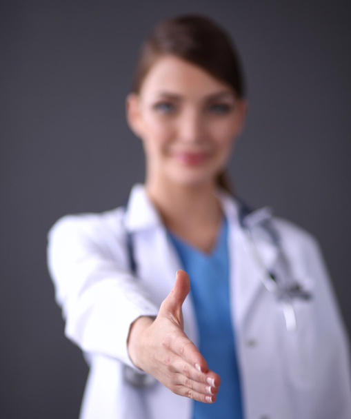 Female doctors handshake , isolated on grey background - Foto, Imagem