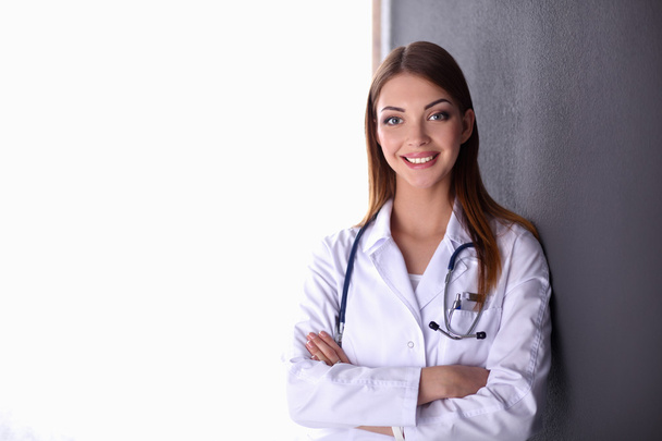 Doctor woman with stethoscope isolated on grey background - Foto, Imagen