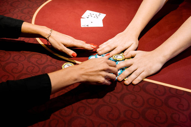 side view of men and women playing poker in a casino - Fotó, kép