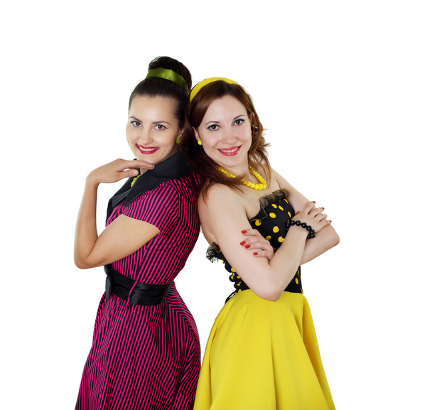 Two young woman in bright colour dresses - Фото, зображення