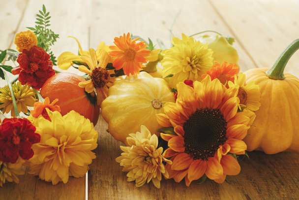 Stylish autumn composition on rustic background. Colorful autumn flowers, pumpkins, pattypan squashes on wooden table. Seasons greeting card, space for text. Happy Thanksgiving! Hello Fall - Photo, image