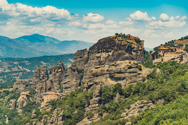 Stunning and breathtaking monasteries of Meteora, Greece built on high rocky formations. Natural view. Drone shot. Blue sky with fluffy clouds. High quality photo - Photo, image