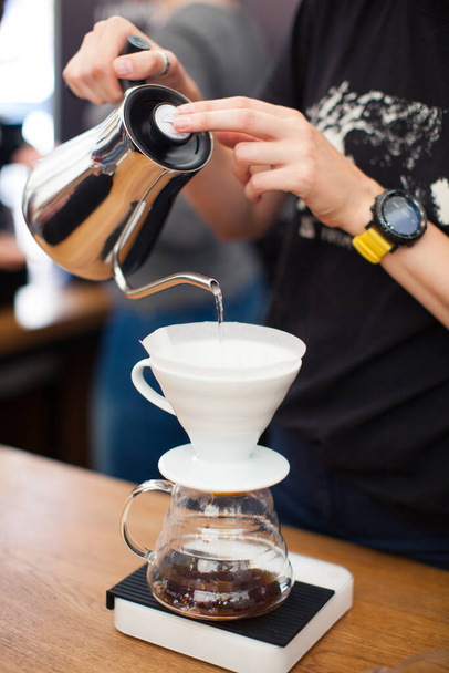 barista pours water from the kettle - Foto, imagen