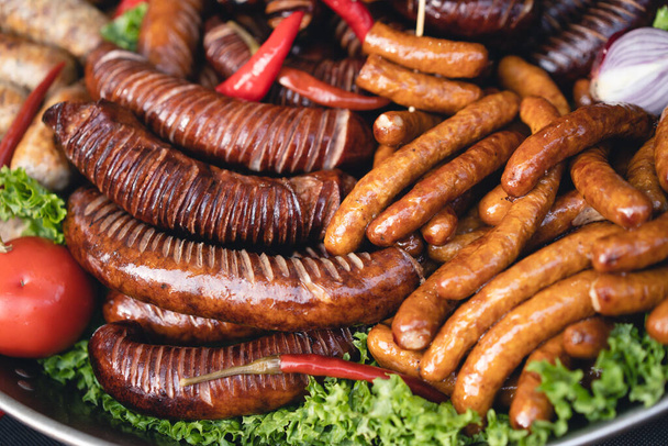 delicious grilled sausages with salad and vegetables - 写真・画像