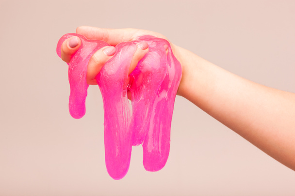a toy for children mucus and liquid flowing on hand - Φωτογραφία, εικόνα