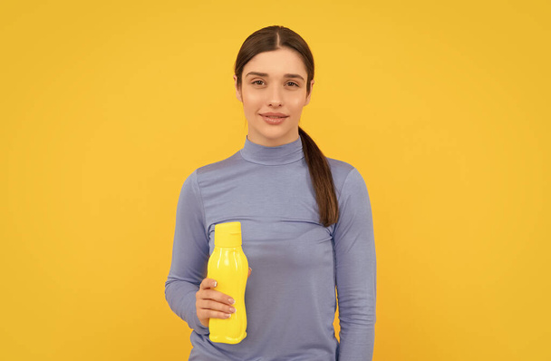 be hydrated. smiling woman hold mineral water. feel thirsty. young girl with sport plastic bottle. healthy lifestyle. water balance in body. drinking per day. hydration vitality. - Photo, Image