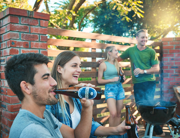 Bring your best buds. Its barbecue time. a group of friends having beers together at a barbecue - Foto, Imagem