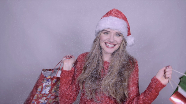 Happy man in Santa Claus hat with christmas gift. Slow motion. - Materiaali, video