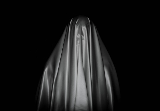 Scary white ghost sheet on black background for Halloween Festival concept. - Foto, afbeelding