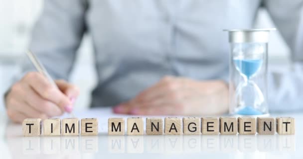 The inscription time management on wooden cubes in the office on the table. Task assessment, prioritization - Filmmaterial, Video