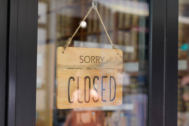 closed we are sorry text wooden board windows door vintage shop sign close store - Photo, image