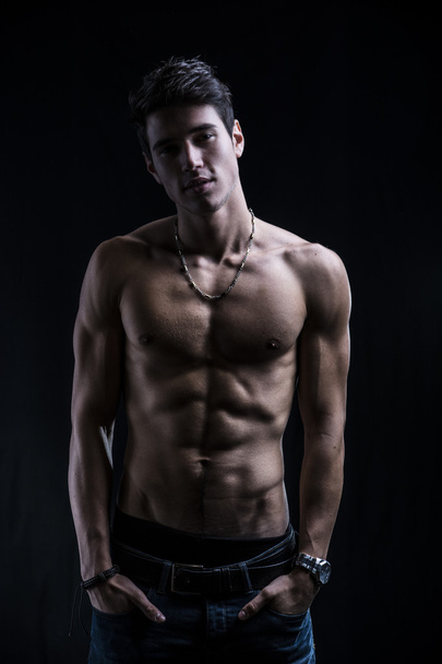 Handsome muscular shirtless young man standing confident - Photo, image