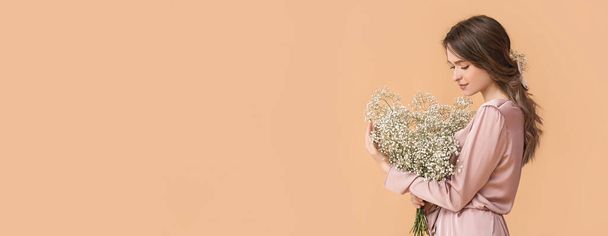 Pretty young woman with bouquet of flowers on beige background with space for text - Foto, Imagem