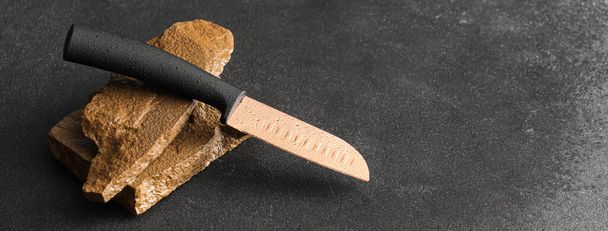 Clean knife with sharpening stones on dark background with space for text - Photo, Image