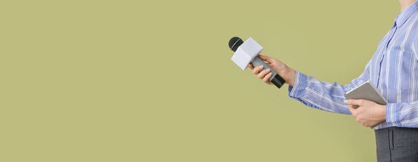 Journalist with microphone on color background with space for text - Fotografie, Obrázek