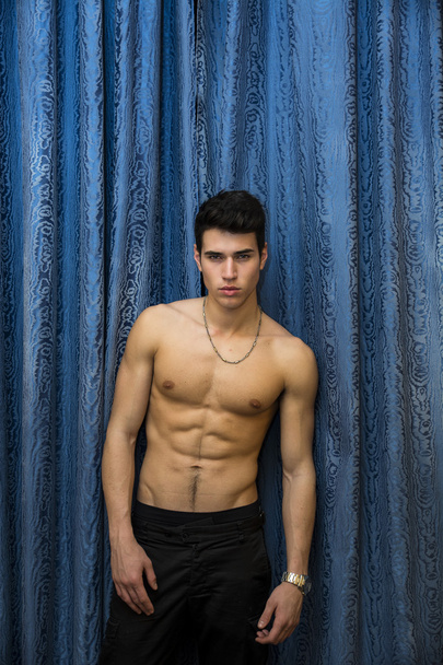 Handsome shirtless muscular young man, looking at camera - Fotó, kép