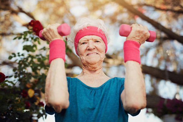 Сохраняйте здоровье, тренируйте тело. пожилая женщина, занимающаяся дома - Фото, изображение