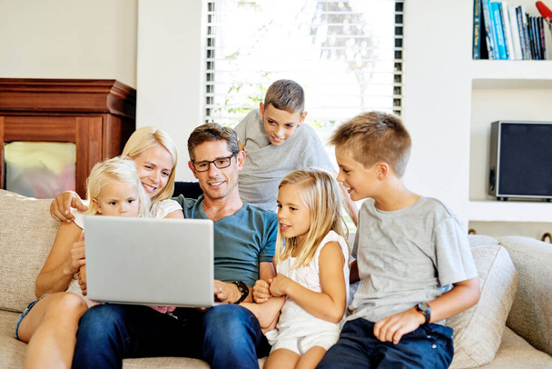 Weekends are for going wireless. a family using a laptop together at home - Foto, immagini
