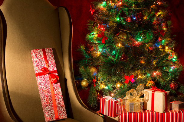Christmas interior with illuminated Christmas tree and chair - Photo, Image