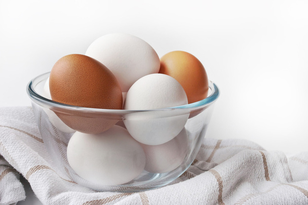 Chicken eggs in a glass dish on the white background  - Foto, Imagen