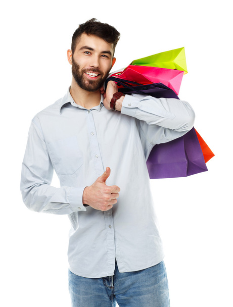 Knappe man bedrijf shopping tassen - Foto, afbeelding