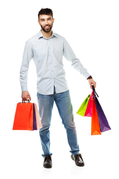 Handsome man holding shopping bags - Foto, Imagen