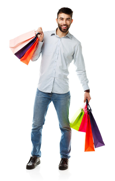 Handsome man holding shopping bags - Фото, зображення
