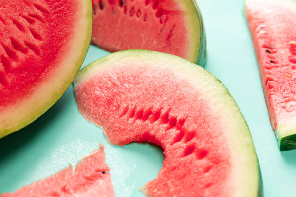 Fruit still life. Fresh juicy red watermelon, watermelon slice over blue background, Design for wallpaper, greeting season card. Summer vitamins, berries. Closeup. - Zdjęcie, obraz