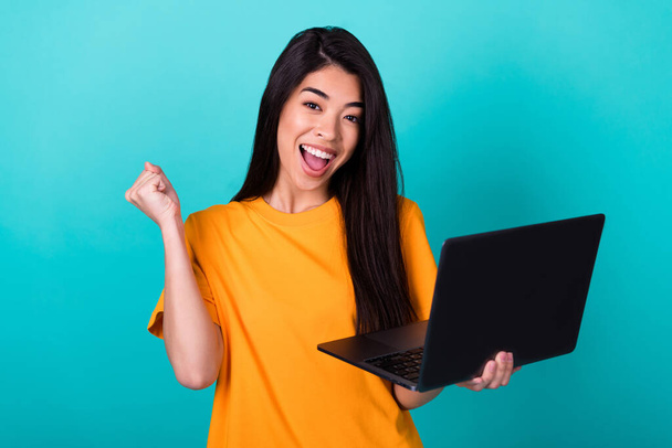Photo of hooray millennial lady hold laptop yell wear orange t-shirt isolated on teal color background. - Fotografie, Obrázek