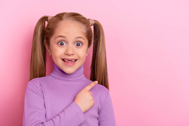 Photo of young little girl with ponytails promote recommend product object isolated on pink color background. - Valokuva, kuva