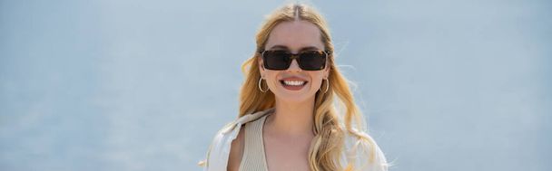 portrait of happy young woman with blonde hair and trendy sunglasses, banner - Foto, immagini
