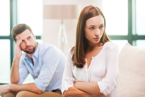 Depressed woman and man sitting behind her - Photo, Image