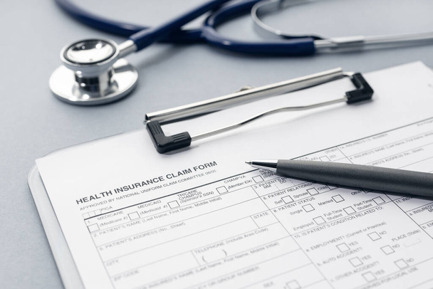 Health Insurance claim form and stethoscope on desk - Photo, image
