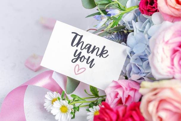Thank you card on blossom flower bouquet and pink ribbons - Photo, Image