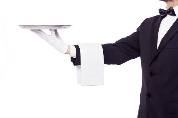 Waiter holding an empty silver tray - 写真・画像