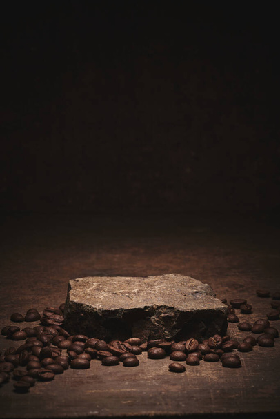 Roasted coffee beans on stone pedestal brown background - Fotografie, Obrázek