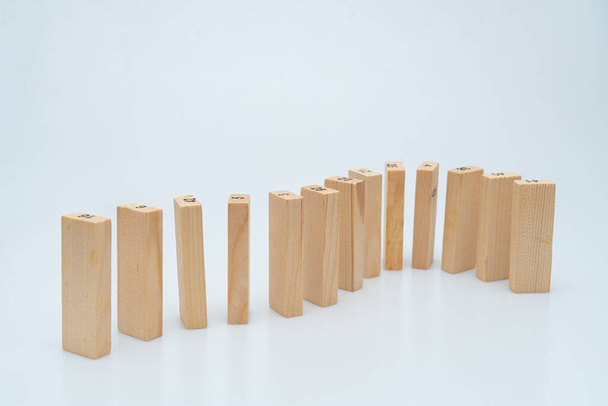 Expressing various concepts such as dominoes and business using wood jenga - Foto, imagen