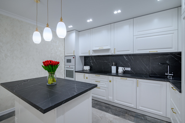 Luxury large modern domestic kitchen furniture with island and black marble worktop - Foto, Bild